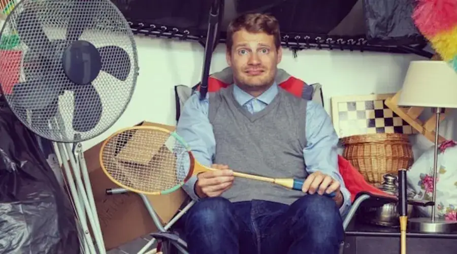 Man surrounded by junk to throw away